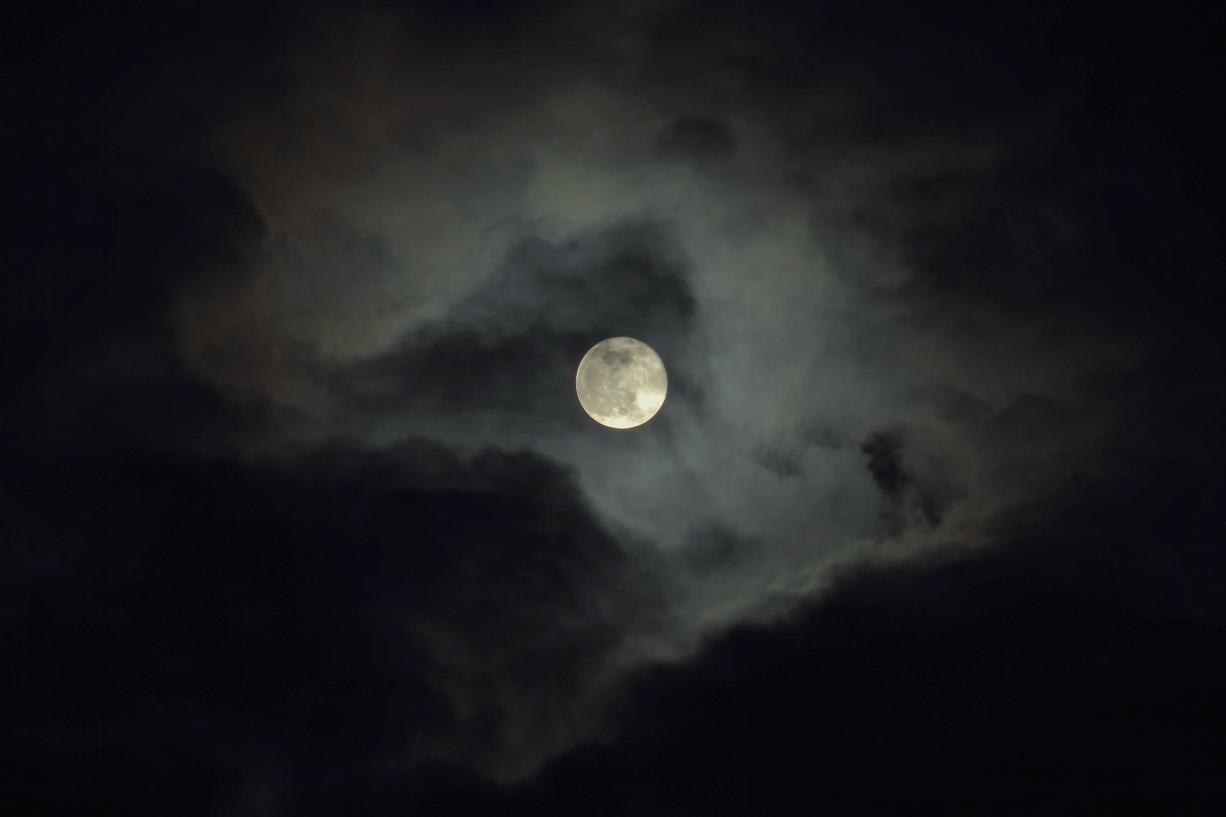 Worm Moon Between Clouds